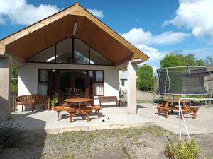 a house with a picnic table and a grill at Abiento in Wexford
