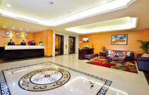 a lobby with a clock in the middle of a room at Fuward Hotel Tainan in Tainan