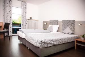 a bedroom with a large bed and a window at Hotel Russweiher in Eschenbach in der Oberpfalz