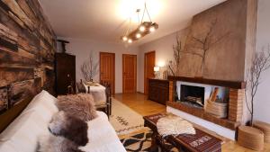 a living room with a couch and a fireplace at Le Case Nel Bosco Terminillo in Terminillo