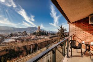a balcony with a view of a city at Ivy Hotel in Tbilisi City