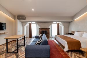 a hotel room with a bed and a fireplace at Ivy Hotel in Tbilisi City