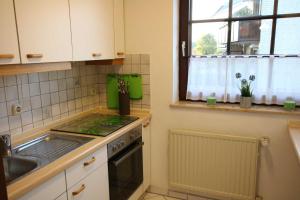 a kitchen with a sink and a stove top oven at Ferienwohnung Marie in Bad Bevensen