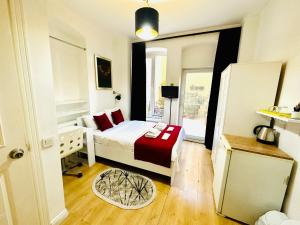 a bedroom with a bed with a red blanket at Aram Galata Suites in Istanbul