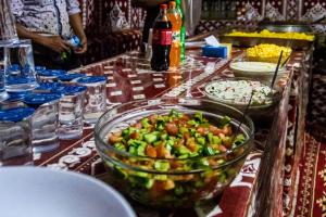 a table with a bowl of food on a table at Wadi Rum stael Luxury Camp in Wadi Rum +35 photos