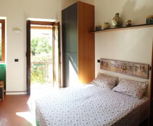 a bedroom with a bed with a white bedspread at Il Carretto Taormina Center in Taormina