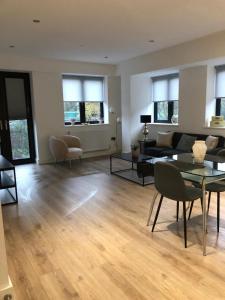 a living room with a couch and a table at Brand new luxury apartment with free parking and gym in Olton