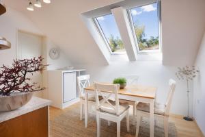 a kitchen and dining room with a table and chairs at Apartments Ladka in Begunje na Gorenjskem
