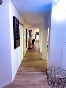a hallway with a woman walking down a hallway at AIR BNBAR N°13 in Schaffhausen