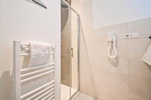 a shower with a glass door in a bathroom at Les cles du 27 Paris in Paris +152 photos