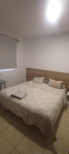 a bedroom with a bed with a laptop on it at Habitación privada Tenefe in Vecindario