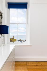 a window with a view of the ocean at Orla-Mo Victorian Captains House,St Ives,Cornwall,Sleeps10-15,Parking4cars,Refurb2022 in St Ives