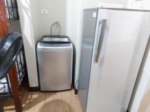 a refrigerator and a trash can in a room at Male Room Sharing in Manila