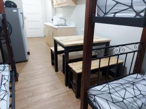 a small kitchen with a table and a bunk bed at Male Room Sharing in Manila