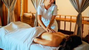 a womanolithing a woman laying on a bed at Cariblue Beach and Jungle Resort in Puerto Viejo +89 photos