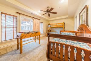 two bunk beds in a bedroom with a ceiling fan at Good Trouble in Kill Devil Hills +142 photos
