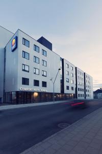 a large building with a train on the side of it at Comfort Hotel Xpress Tromsø in Tromsø