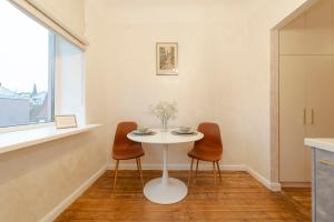 a table and two chairs in a room with a window at G11 Old Riga in Rīga