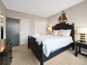 a bedroom with a large bed with a black headboard at Lake front Keowee Condo with Balcony & Resort Amenities! 20 min to Clemson condo in Salem
