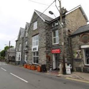 a brick building on the side of a street at Harlech/HUGE Three bedroom/BEST location in Llanbedr