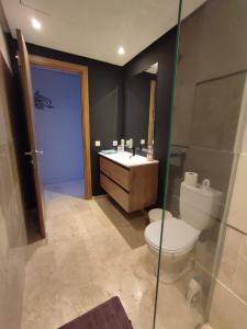 a bathroom with a toilet and a sink at LUXURY 3 bedroom apartment with pool, Nouaceur, Morocco in Derroua