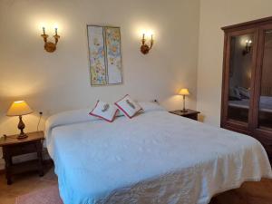 a bedroom with a bed with two books on it at Casa Familiar y Acogedora in Sa Pobla