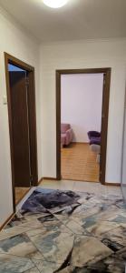 an empty room with a door and a room with a couch at Two Rooms Parc Ior Apartament in Bucharest