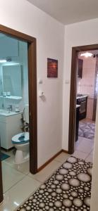 a bathroom with a toilet and a sink at Two Rooms Parc Ior Apartament in Bucharest