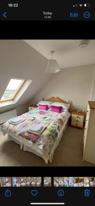 a bedroom with a bed with a comforter and pillows at Donard View Penthouse in Newcastle