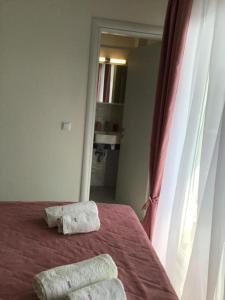 a bedroom with a bed with two towels on it at Estia House M in Nikiti