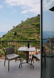 una mesa y sillas con vistas a una colina en Il Bordone - appartamento con vista mare, en Manarola