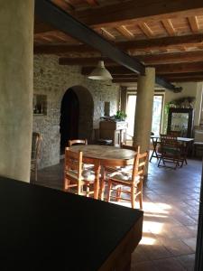 a dining room with a wooden table and chairs at Stone farmhouse in Moie in Moie +23 photos