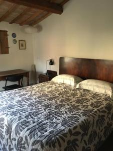 a bedroom with a large bed and a desk at Stone farmhouse in Moie in Moie