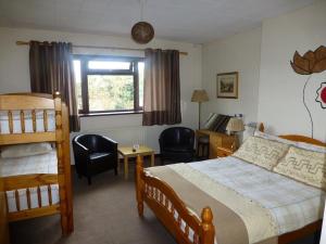 a bedroom with a bed and a desk and a bed and chairs at Woodlands Hotel in Birmingham