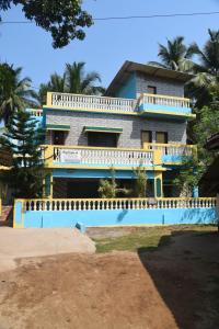 a building with a pool in front of it at NISARG HOME STAY near Bus Stand Malvan in Malvan