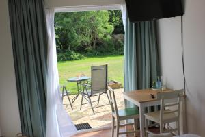 a room with a window with a table and chairs at Bluesheep-texel in De Koog