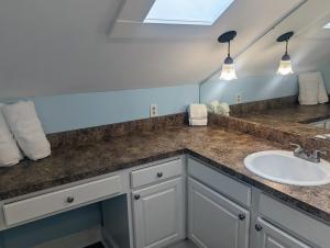 a bathroom with a sink and a mirror at Villas de Frenchmen in New Orleans +80 photos