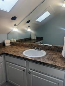 a bathroom with a sink and a mirror at Villas de Frenchmen in New Orleans