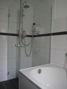 y baño con ducha y lavabo blanco. en Ferienwohnung Schlossblick, en Amtzell