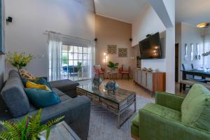 a living room with two couches and a table at Villa Tamar in Palm-Eagle Beach