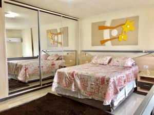 a bedroom with two beds and a large mirror at Saint Sebastian Flat 206 - Com Hidro! até 4 pessoas, Duplex, no centro in Jaraguá do Sul