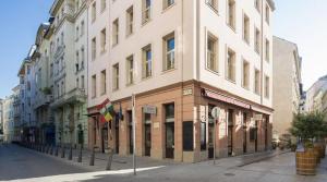 a large building on a city street with buildings at Three Corners Hotel Art in Budapest