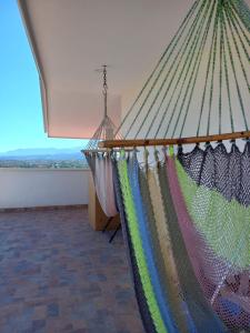 a hammock in a room with a large window at Hotel y Plaza JMI in Siguatepeque