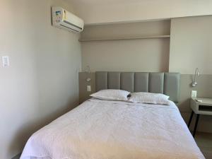 A bed or beds in a room at Flat Hotel à Beira Mar Recife by Direct