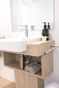 a bathroom with a sink and a mirror at Port Lincoln Beachfront Apartment 7 in Port Lincoln