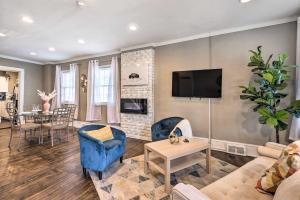 a living room with a couch and a tv at Baltimore Vacation Rental Near Dtwn Towson! in Baltimore