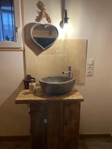 a bathroom with a sink with a heart on the wall at Love House "L'évasion Secrète" in Rivesaltes