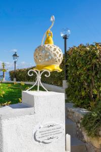 a statue of a bell on top of a wall at Holidays Perla d'Amalfi - Live the Coast & Private Parking in Amalfi +57 photos