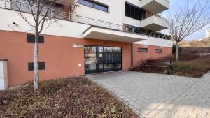 a building with a bench in front of it at Air-conditioned, 2 room Apartment with balcony, new building Rača in Bratislava
