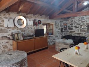 ein Wohnzimmer mit einer Steinmauer in der Unterkunft Moinho do ribeirinho, renovado vintage in Campos de Sá